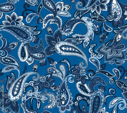 Seamless navy blue and white paisley pattern on a blue background. Traditional batik flower motif for textile fabrics.