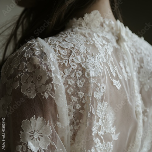 Delicate lace embroidery on elegant bridal gown fabric. photo