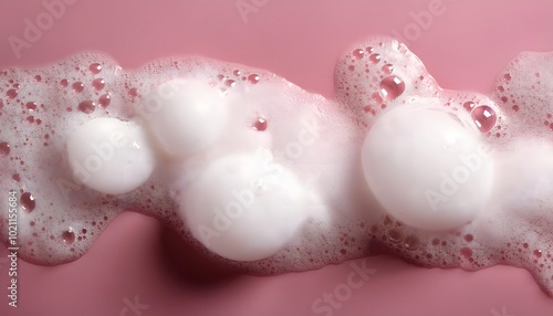 Shampoo foam with large, soft bubbles against a pastel-colored background