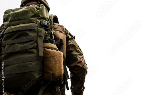 A soldier carrying a tactical backpack prepares for a mission in a rugged outdoor setting, showcasing military readiness.