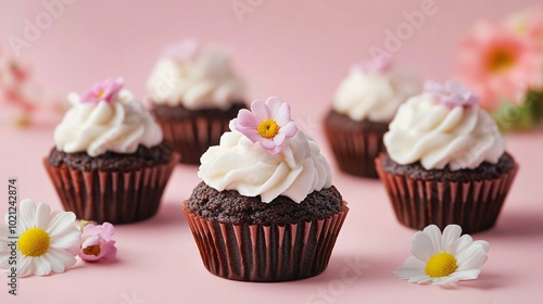 Mini Jamaican Black Cakes in cupcake form, isolated on a light pastel background with delicate floral decorations