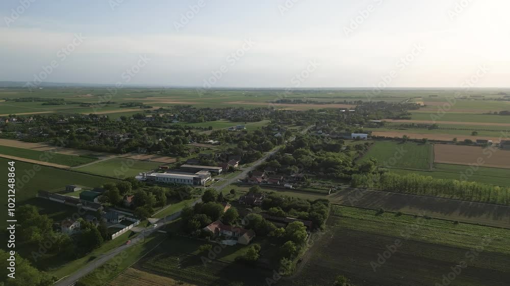 Aerial drone view of crop fields with nearby town Aerial drone view of crop fields with nearby town