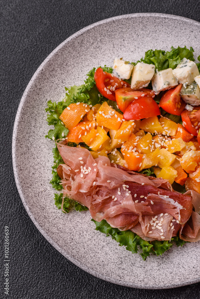 Appetizing salad with prosciutto, pumpkin, cheese and tomatoes Appetizing salad with prosciutto, pumpkin, cheese and tomatoes