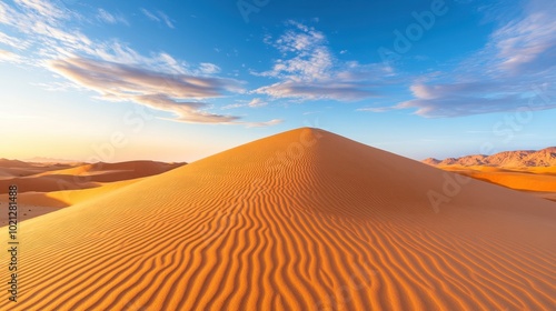 Endless sand dunes shaped by the wind, creating an otherworldly desert landscape bathed in the soft glow of the setting sun.