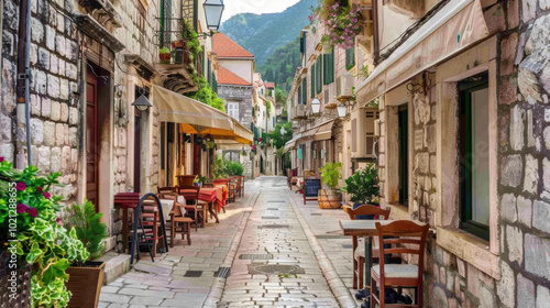 Narrow street in a European city with old buildings and charming outdoor cafes.