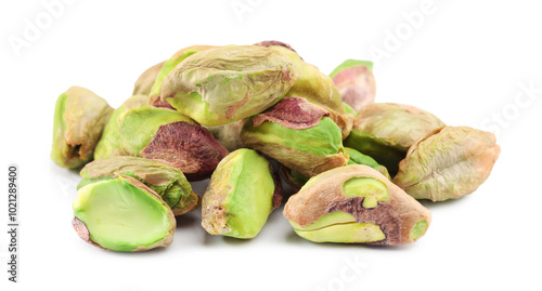 Tasty peeled pistachio nuts isolated on white