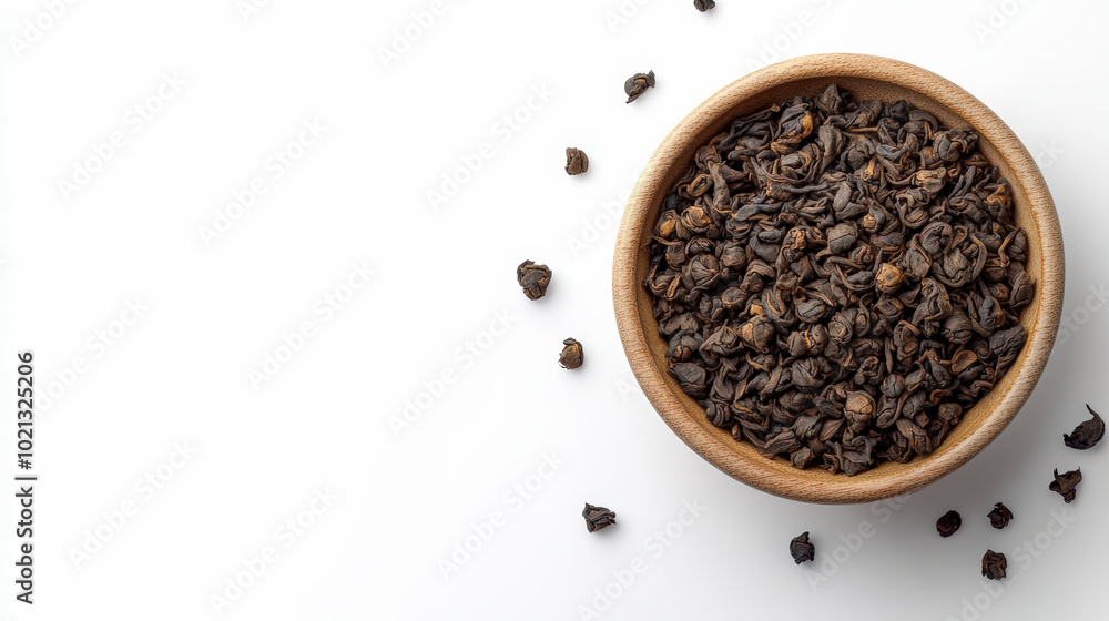 A wooden bowl filled with loose leaf tea rests on a white surface, surrounded by a few scattered tea leaves, evoking warmth and flavor. A wooden bowl filled with loose leaf tea rests on a white surface, surrounded by a few scattered tea leaves, evoking warmth and flavor.