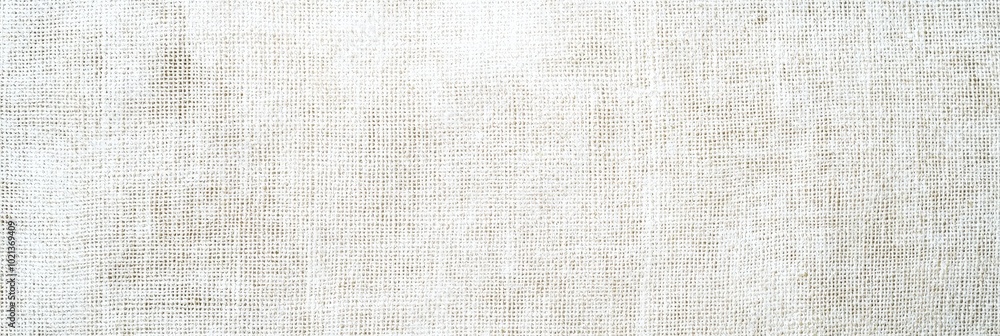 The soft, natural linen fabric is elegantly arranged on a wooden surface, showcasing its texture and subtle color variations illuminated by daylight The soft, natural linen fabric is elegantly arranged on a wooden surface, showcasing its texture and subtle color variations illuminated by daylight