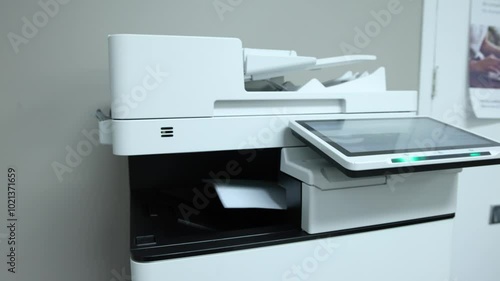 Multifunction printer printing multiple documents in an office setting, quebec, showcasing modern efficiency. Selective focus