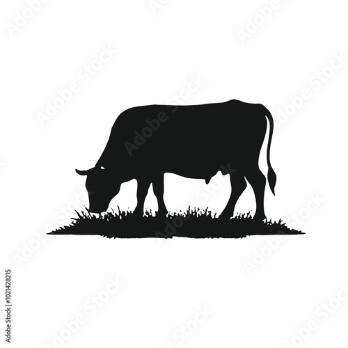 A black silhouette of a cow grazing in a grassy field