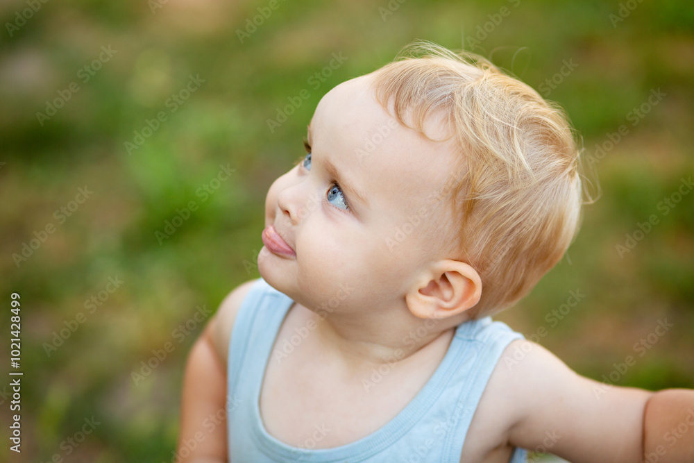 portrait of a cute blond child in the yard on summer nature, children's emotions on the face portrait of a cute blond child in the yard on summer nature, children's emotions on the face