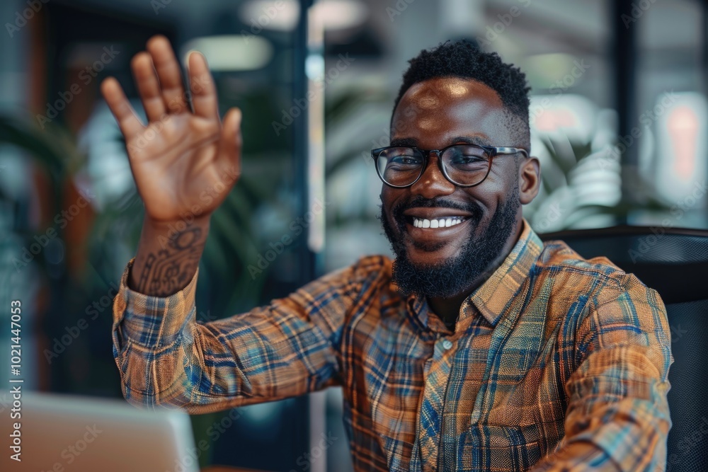 Cheerful African American office worker giving high five to colleagues and looking at camera. Cheerful African American office worker giving high five to colleagues and looking at camera.