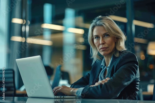 Shot of an attractive mature businesswoman working on laptop in her workstation. photo