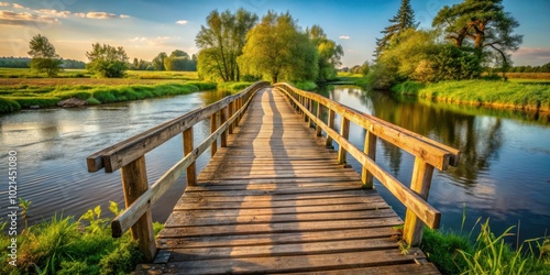 A wooden bridge stretches across a serene river, bathed in the warm glow of a golden sunset, with lush greenery framing the picturesque scene.