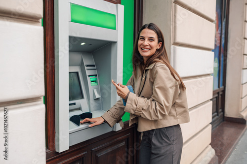 Canvastavla Woman withdrawing cash from atm and smiling
