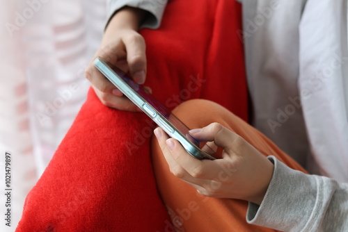 Close up of a boy's hands holding a smartphone and playing a game on the smartphone