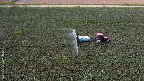Aerial View of Tractor Spraying Defoliant on Cotton Field