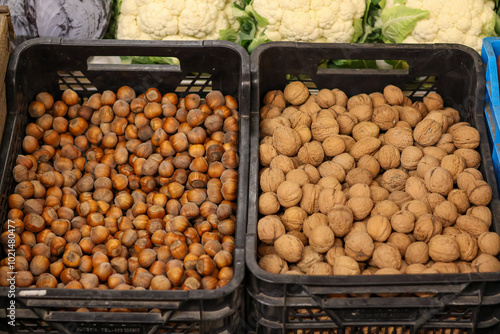 A close-up of walnuts and hazelnuts lying next to each other photo