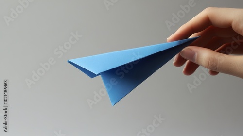 Imagine a hand making a blue paper airplane. 