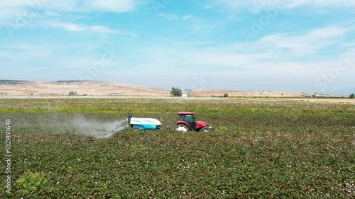 Aerial View of Tractor Spraying Defoliant on Cotton Field