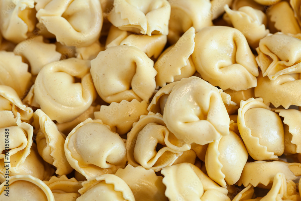 Fresh raw tortellini or capeletti background Fresh raw tortellini or capeletti background