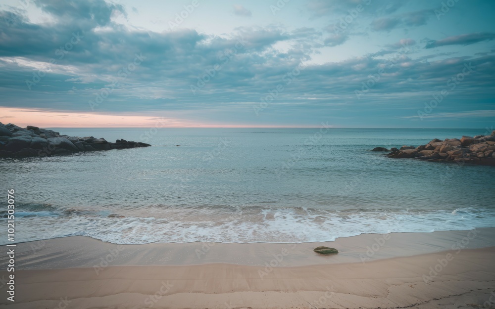 Fototapeta premium Tranquil beach shore. Serene beach scene with soft waves and sandy shore, symbolizing peace and serenity.