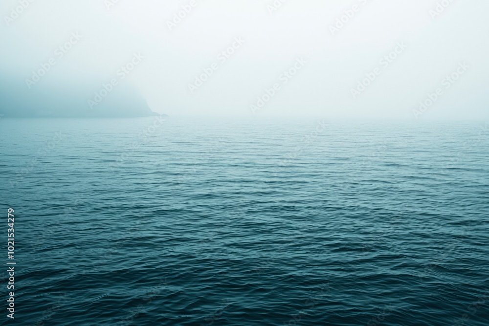 A Silhouette of Land Emerging From a Misty Sea A Silhouette of Land Emerging From a Misty Sea