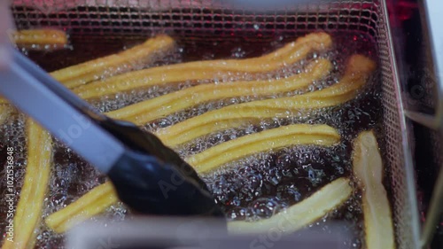 Churros that get turned in hot oil while baking