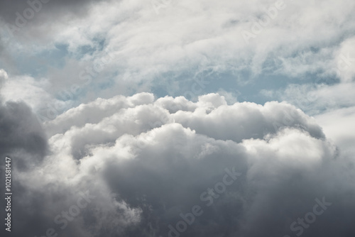 View inside a cloud at altitude, cloud and the turquoise sky peeking through it in close-up