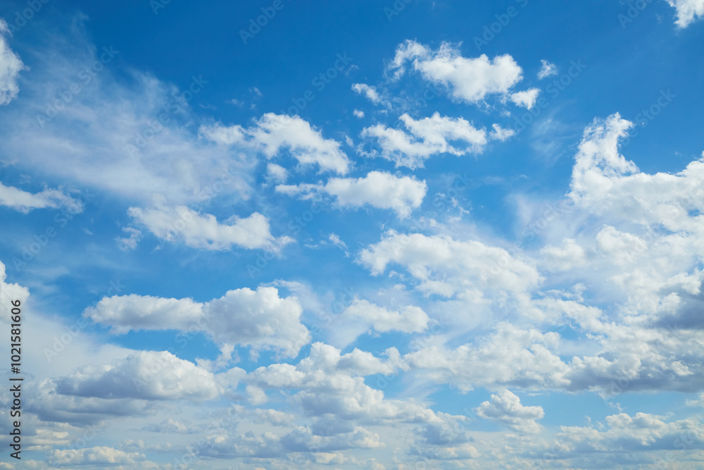 White clouds in the blue sky, light on the clouds in the sky White clouds in the blue sky, light on the clouds in the sky