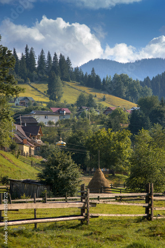 landscape in the Carpathians, wooden fences, country yards, haystacks and far...