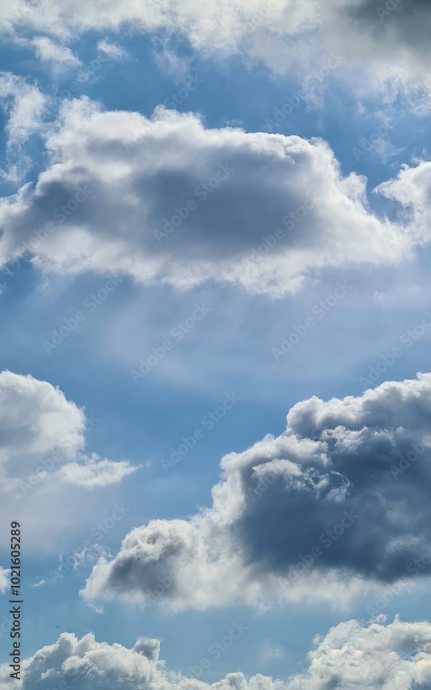 A photo of the sky with fluffy clouds against a bright blue backdrop. A tranquil atmosphere with light filtering through the clouds. A photo of the sky with fluffy clouds against a bright blue backdrop. A tranquil atmosphere with light filtering through the clouds.