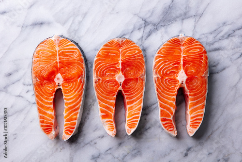 Salmon steaks, fillet. White marble background. Close up. Top view. photo