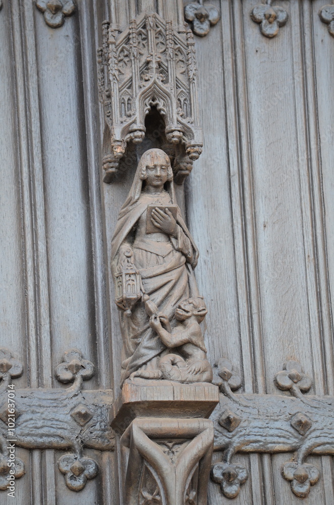 Fototapeta premium Intricate Wooden Sculpture of a Saint on a Gothic Door in Brussels 