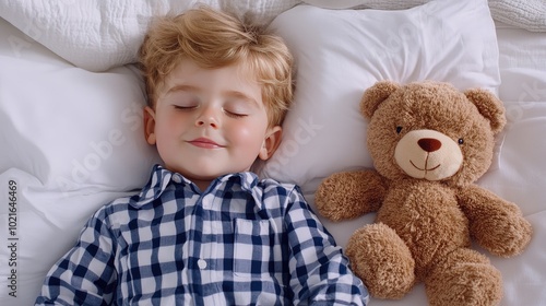 A young boy sleeps soundly with his teddy bear, nestled among scattered rose petals on a soft white blanket, creating a serene and sweet atmosphere