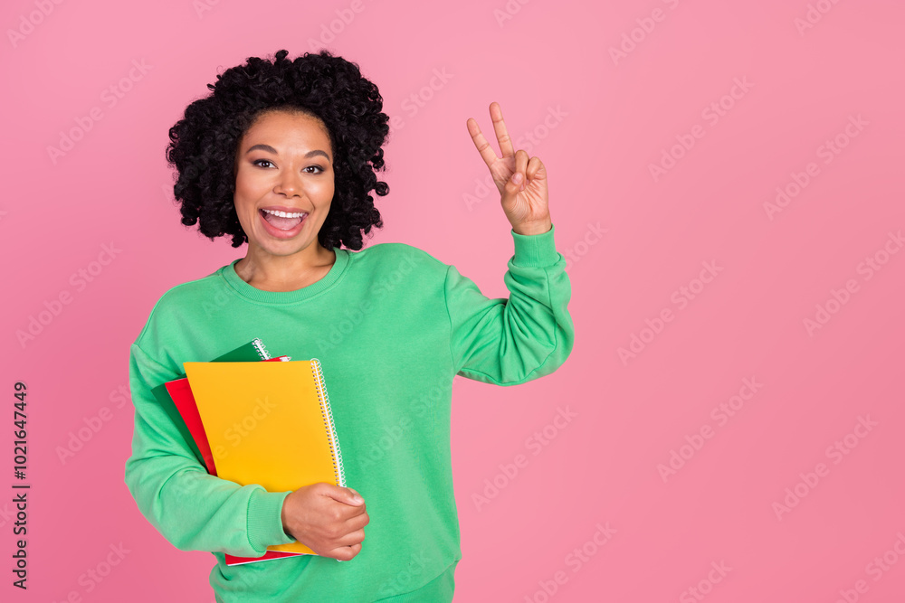 Photo of shiny attractive lady dressed green pullover showing v-sing reading book empty space isolated pink color background Photo of shiny attractive lady dressed green pullover showing v-sing reading book empty space isolated pink color background