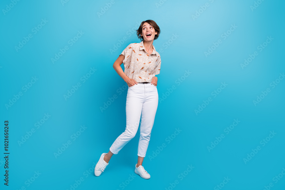 Full length photo of cheerful gorgeous person put hands pockets look empty space isolated on blue color background Full length photo of cheerful gorgeous person put hands pockets look empty space isolated on blue color background