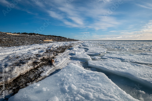 Obraz na płótnie Anticosti Stunning Rocky Coastline with Split Ice on the Seawater Surface in Fractal Patterns Seen From a Low Perspective in the Northern Atlantic Ocean in Winter w salonie