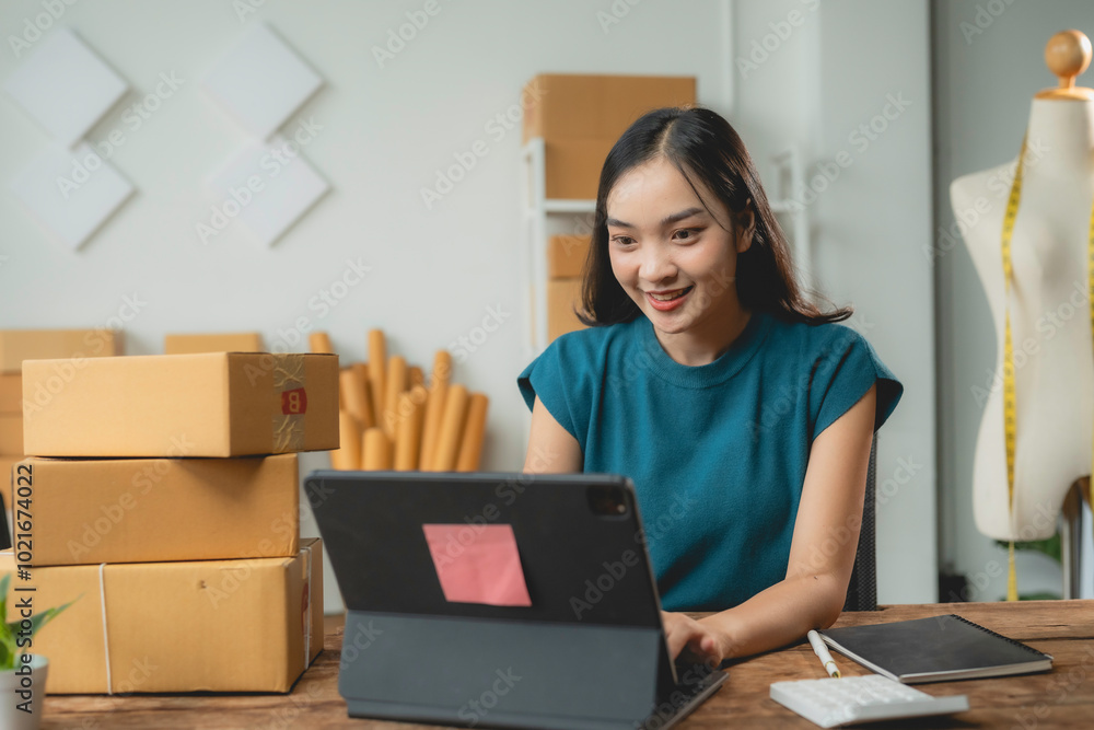 Young asian woman entrepreneur is working from home office using digital tablet to check customer order on online shopping platform Young asian woman entrepreneur is working from home office using digital tablet to check customer order on online shopping platform