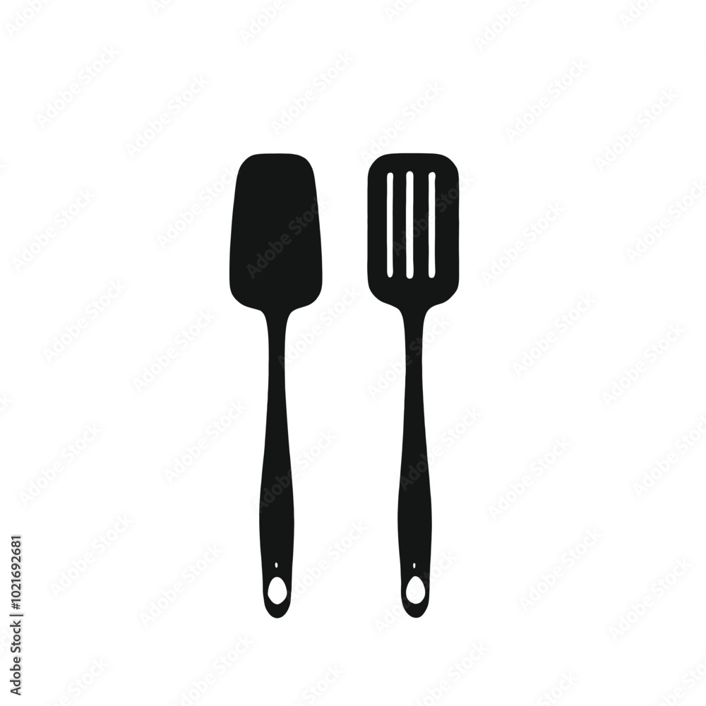Two black kitchen utensils, a spatula and a slotted spoon, on a white background Two black kitchen utensils, a spatula and a slotted spoon, on a white background