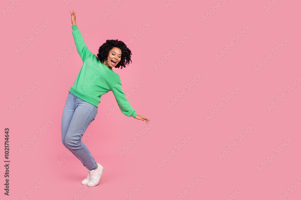 Full length photo of cheerful pretty lady dressed green pullover having fun empty space isolated pink color background Full length photo of cheerful pretty lady dressed green pullover having fun empty space isolated pink color background