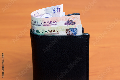 Gambian dalasi in the black wallet photo