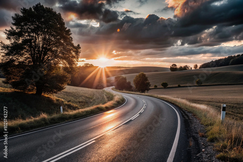 Winding country road at sunset