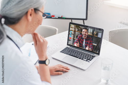 Adult man talking to woman doctor using video conference on laptop gadget. Doctor and patient online, telemedicine concept