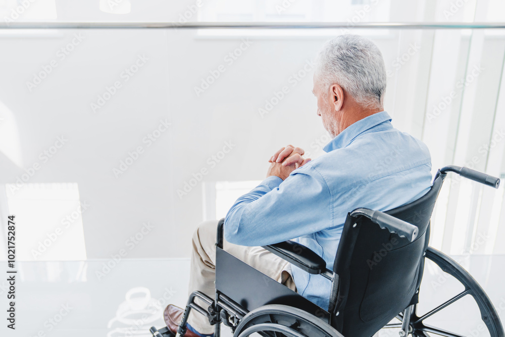 Old sad man sitting on wheelchair feeling lonely and waiting for take care