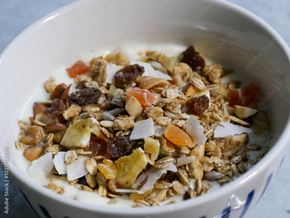 Breakfast bowl with yoghurt and muesli in it. A spoon in it. Breakfast food. home made. Breakfast bowl with yoghurt and muesli in it. A spoon in it. Breakfast food. home made.