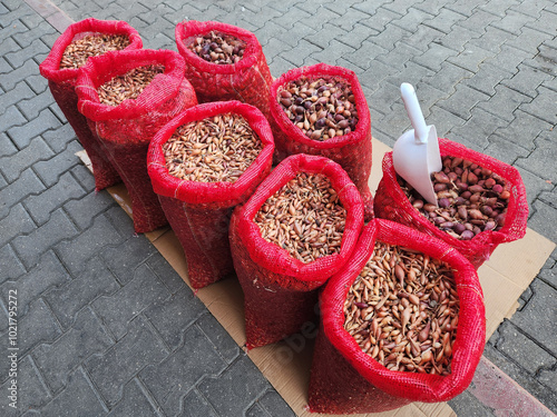 Onion shallots which are planted in house gardens to produce green leaf onions as a winter vegetable are sold in bags at a seed shop in a bazaar place photo