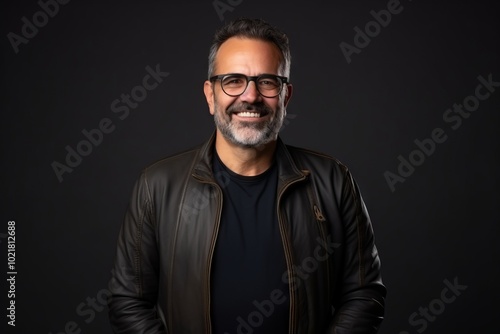 Portrait of a handsome Indian man wearing a leather jacket and glasses