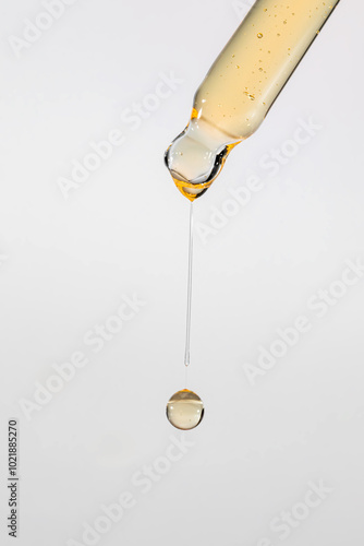 Wallpaper Mural Pipette with serum, gel, oil or other cosmetic product with falling drop. Macro closeup Torontodigital.ca