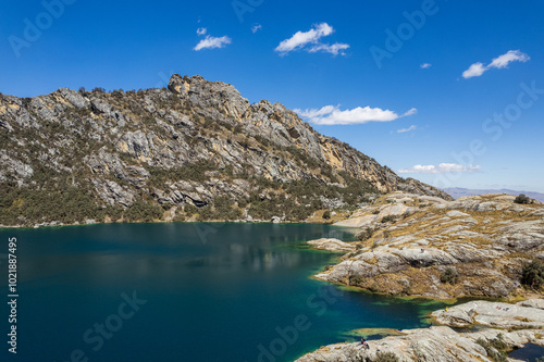 Obraz na płótnie The Turquoise Waters of Churup Lagoon with Tourists Aerial View in the Cordillera Blanca Mountain in the Huascaran National Park, in Ancash, Peru w salonie